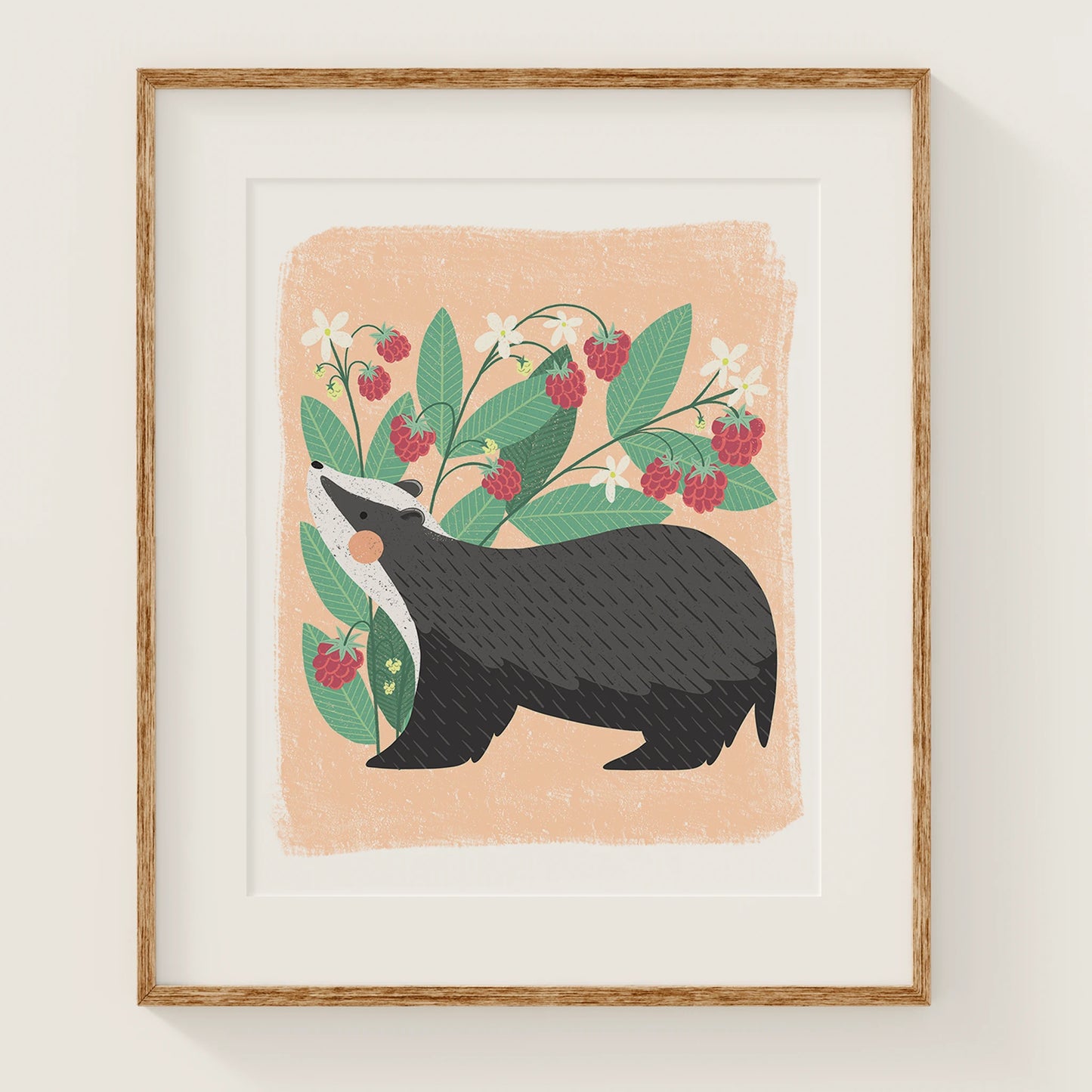 'berry bandit' art print, shown in a wood frame. print features a whimsical badger in front of a cute raspberry plant.