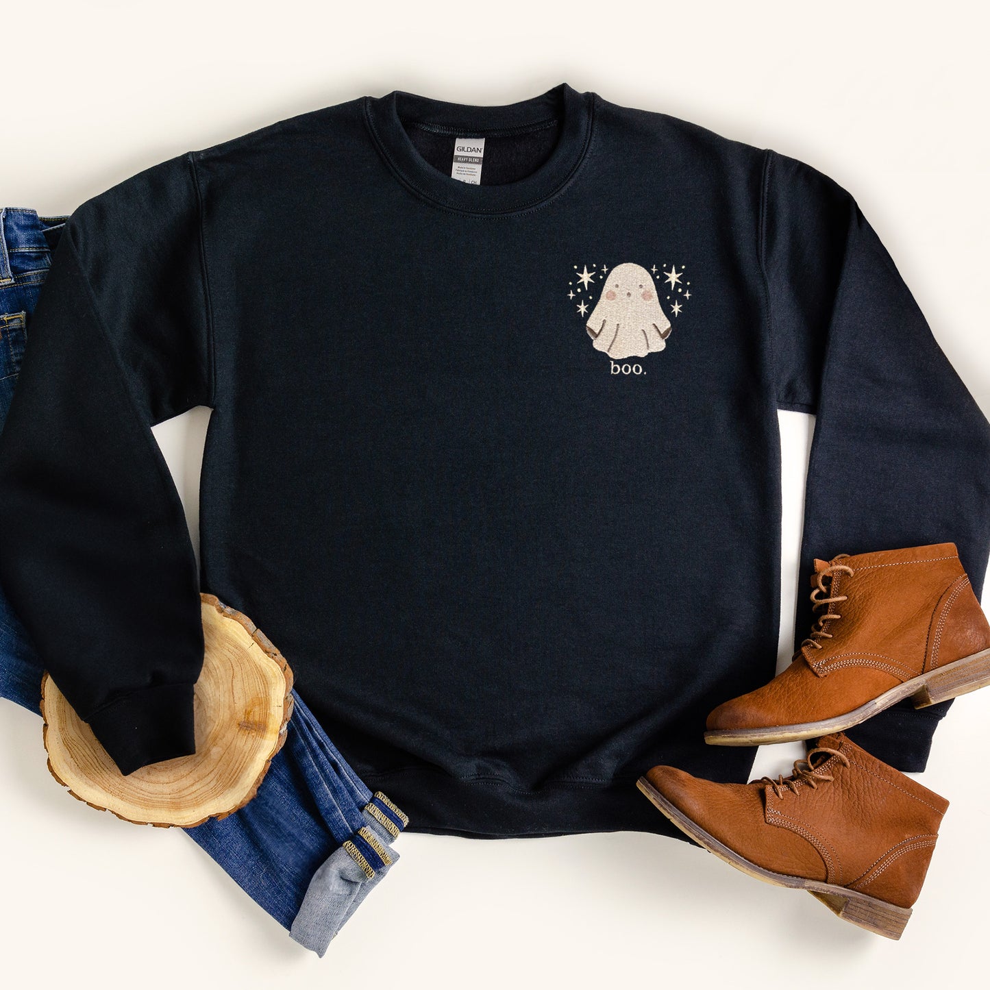 black sweatshirt with a cute ghost embroidered over the left side (pocket-placement) ghost is surrounded by stars with text underneath 'boo.'