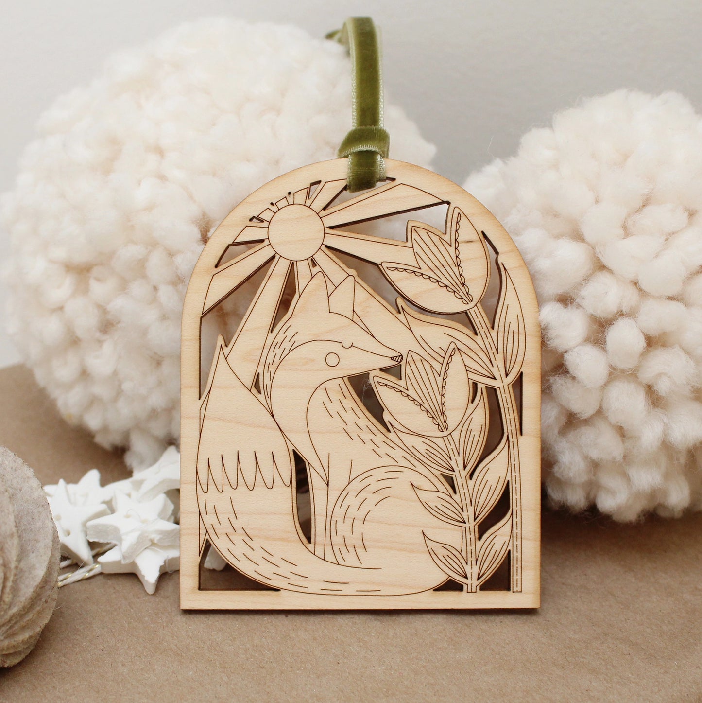 wooden fox arch shaped ornament with etched flowers and a sunshine.