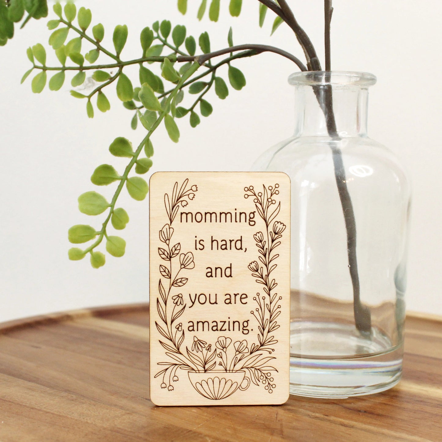 unique mini wood mother's day card that reads 'momming is hard and you are amazing' decorated with flowers coming from a mug.