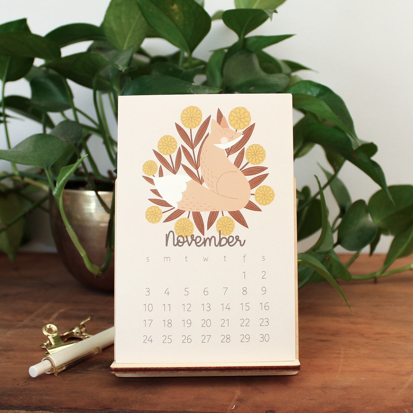 woodland animal 2024 desk calendar showing the month of november with a fox and yellow flowers.