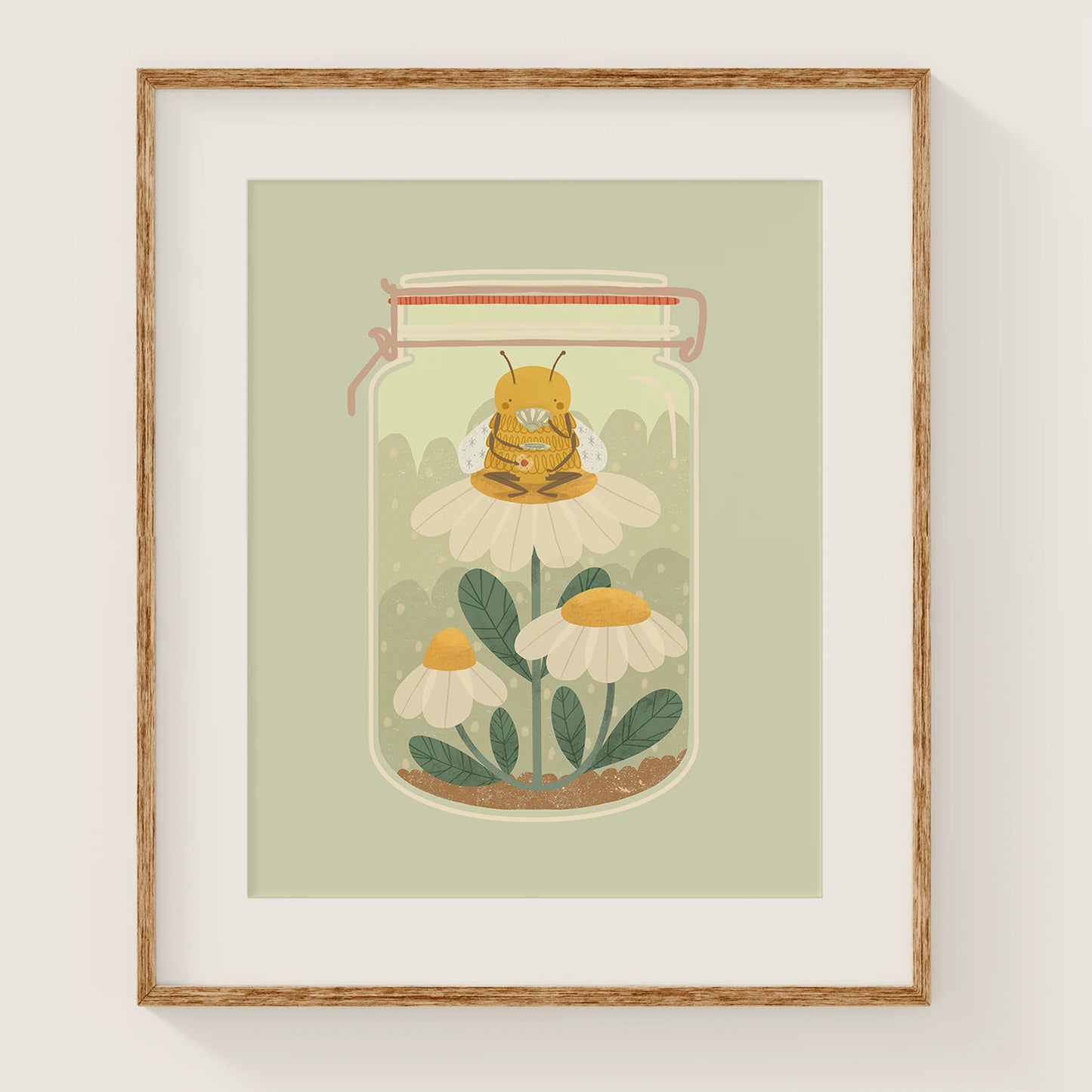'the bee's teas' art print, shown in a wood frame. print features a bee sitting on top of a daisy, sipping tea and holding a cookie. all of this takes place in a jar.