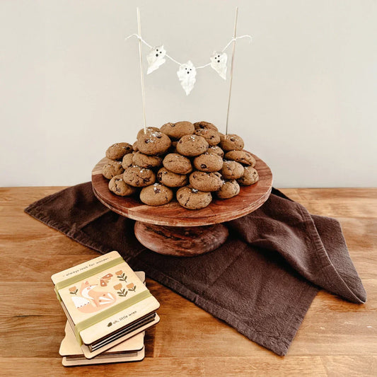 flower pressed ghosts leaves made into a garland decorating the top of a stack of pumpkin cookies. 