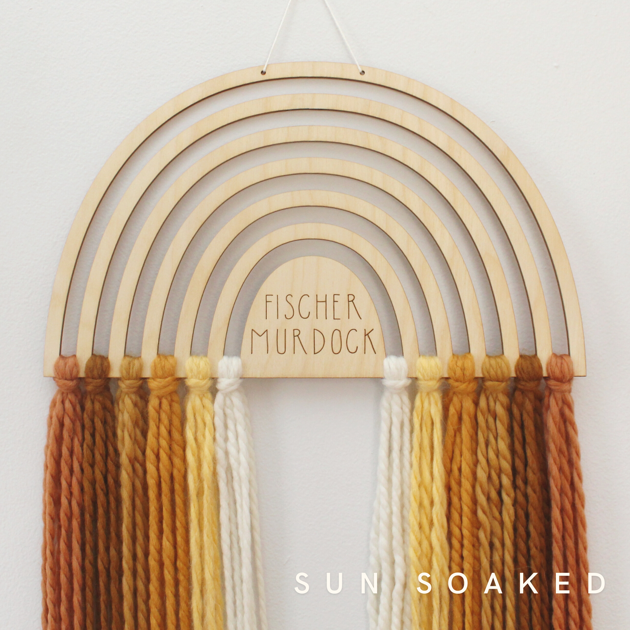 personalized wood and yarn rainbow wall hanging