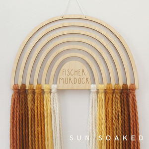 personalized wood and yarn rainbow wall hanging