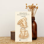 load image into gallery viewer, wooden woodland animal magnet pair with a rabbit and fox with leafy details
