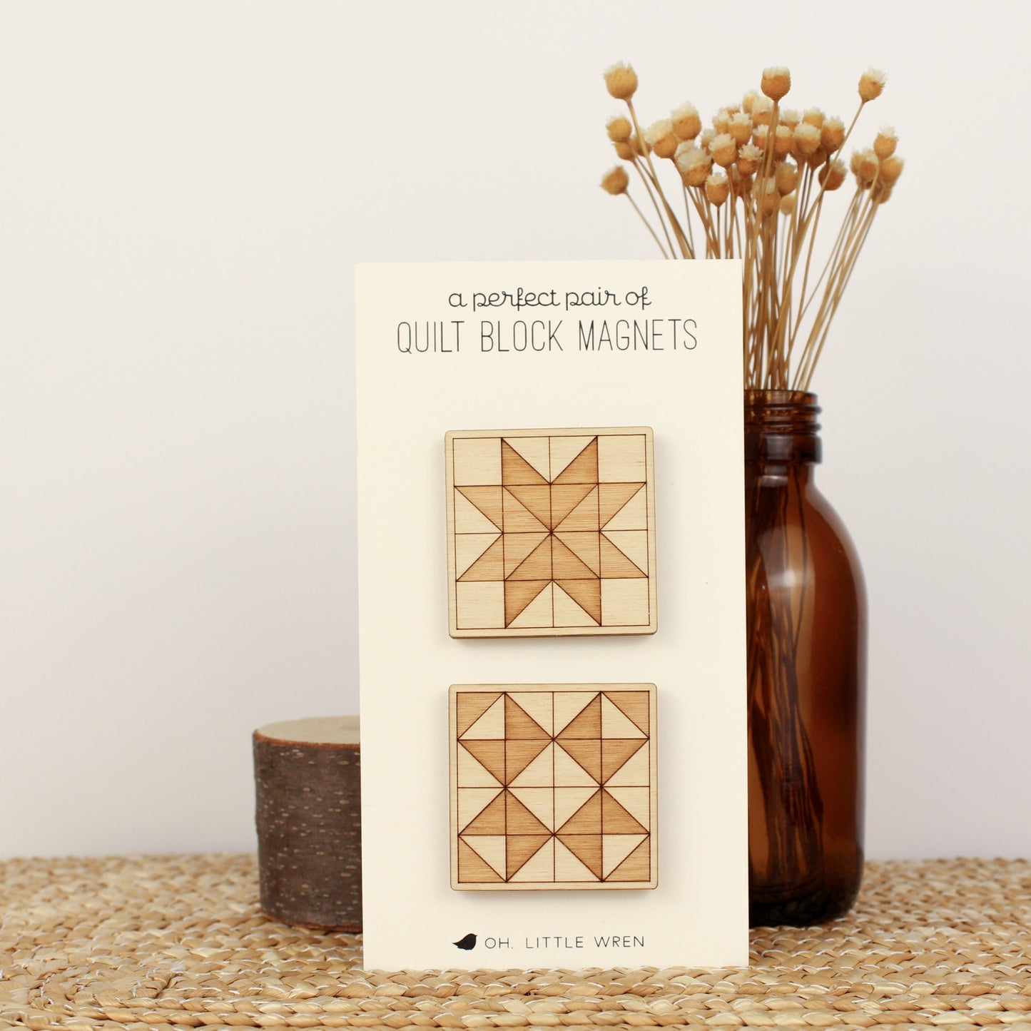 pair of wooden quilt block magnets featuring two different quilt block star designs in a two-toned wood etch.