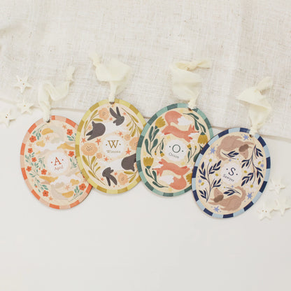All 4 illustrated wooden ornaments arranged against a light background. From left to right there is cat, rabbit, fox, and dog.