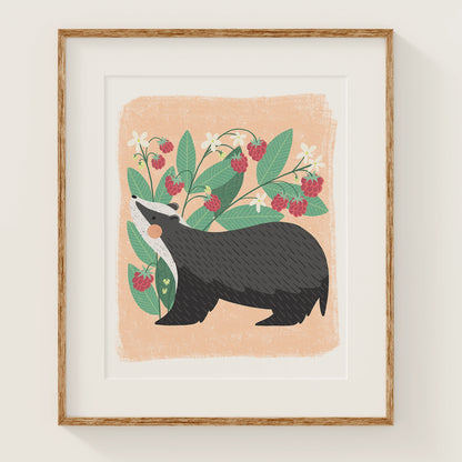 'berry bandit' art print, shown in a wood frame. print features a whimsical badger in front of a cute raspberry plant.