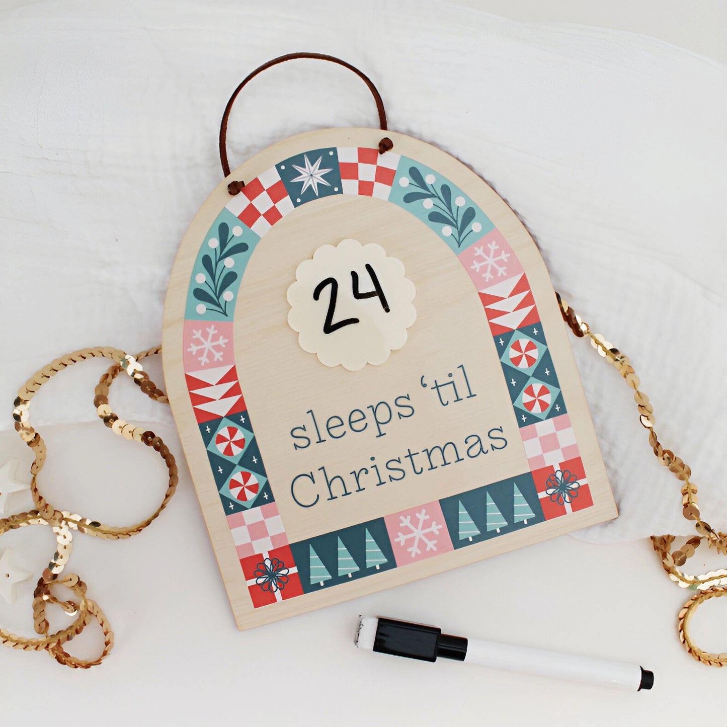 wood countdown sign with 'sleeps 'til Christmas' text and decorative patterns on a white background