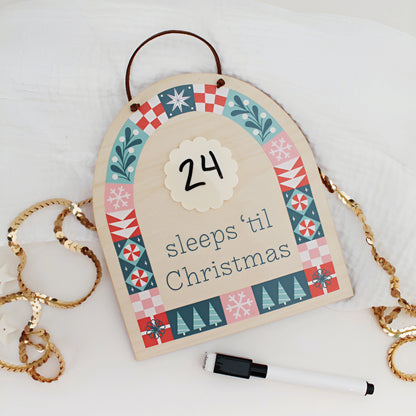 wood countdown sign with 'sleeps 'til Christmas' text and decorative patterns on a white background
