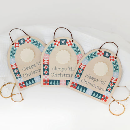 three wood countdown sign with 'sleeps 'til Christmas' text and decorative patterns shown on a white background