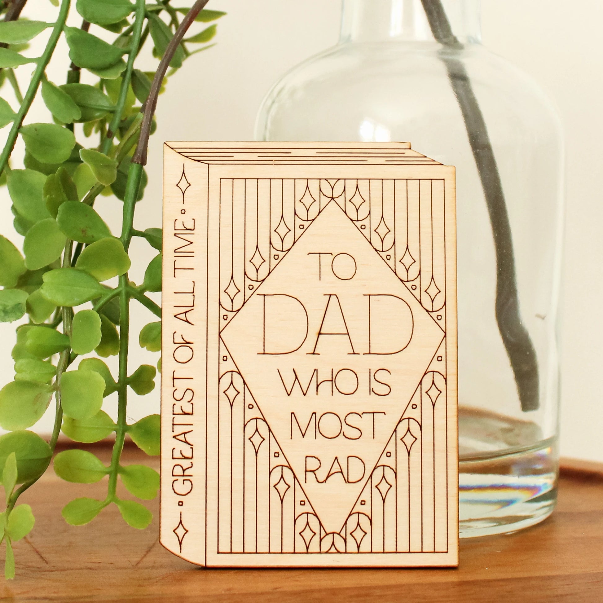 mini wood book shaped card. cover text reads 'to dad who is most rad' and spine text reads 'greatest of all time'