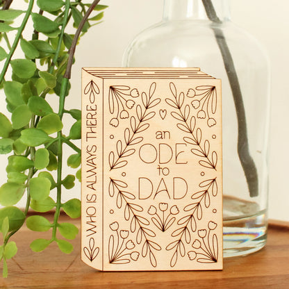 mini wood book shaped card. cover text reads 'an ode to dad' and spine text reads 'who is always there'