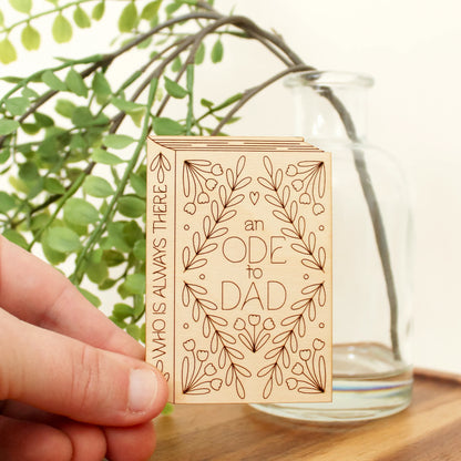 mini wood book shaped card. cover text reads 'an ode to dad' and spine text reads 'who is always there'