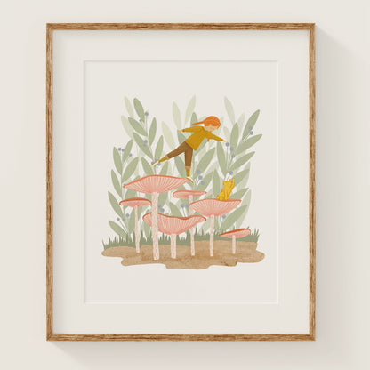 leaning in art print, shown in a wood frame. print features a girl, balancing on one foot on a mushroom with a cute cat nearby.