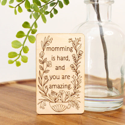 unique mini wood mother's day card that reads 'momming is hard and you are amazing' decorated with flowers coming from a mug.