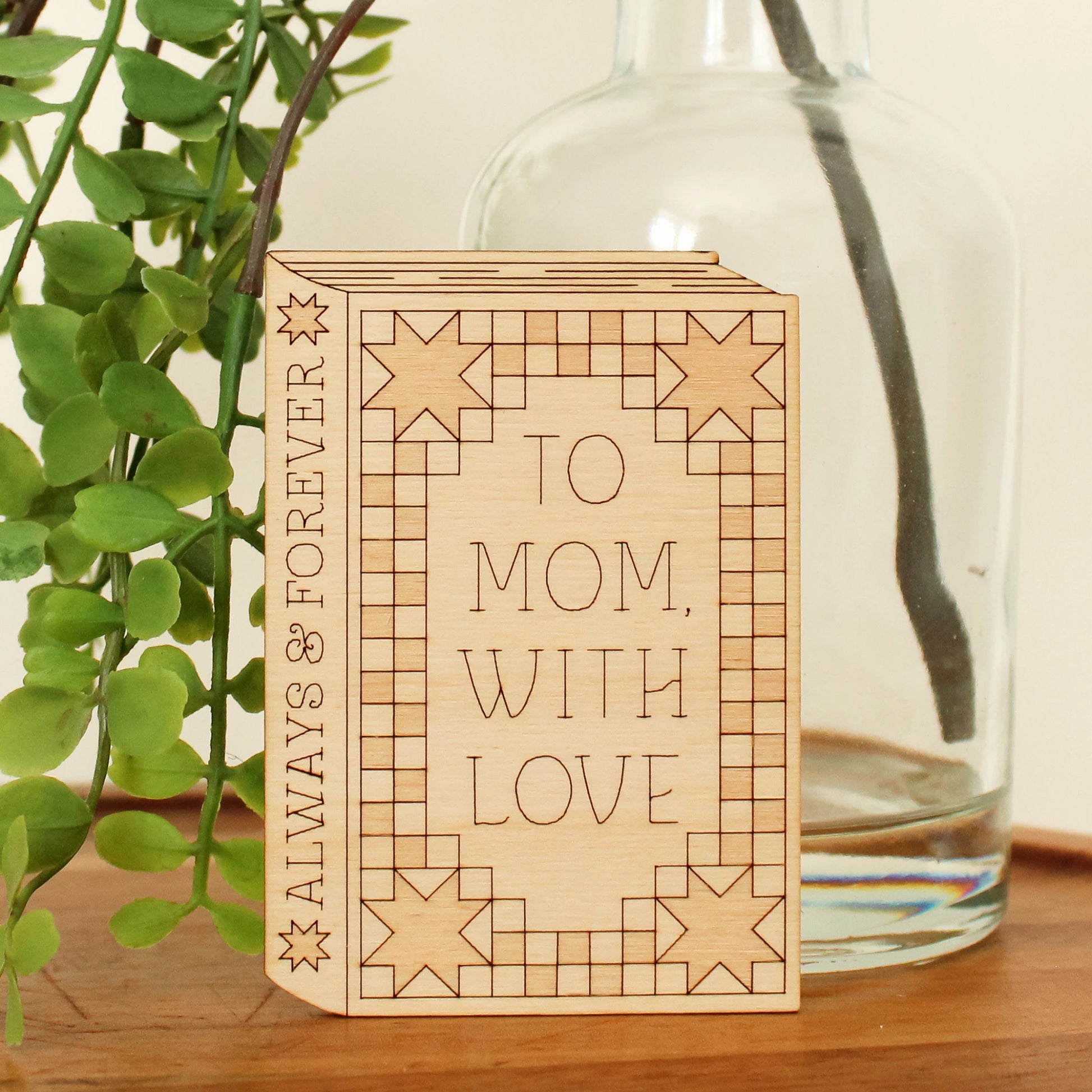 wooden book shaped card with quilt motifs. cover reads 'to mom with love'. spine reads 'always & forever'.