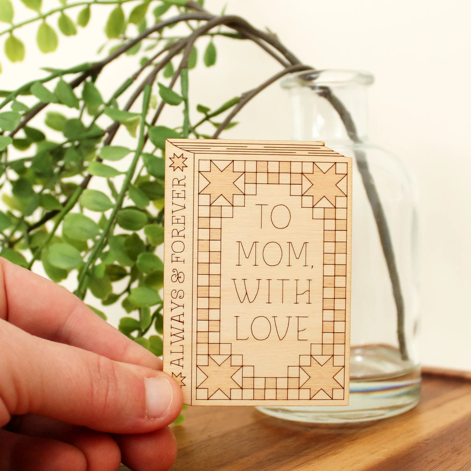 wooden book shaped card with quilt motifs. cover reads 'to mom with love'. spine reads 'always & forever'.