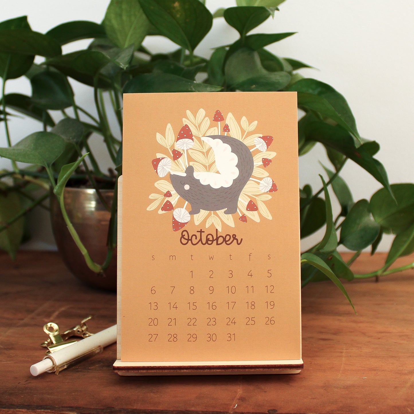 woodland animal 2024 desk calendar showing the month of october with a skunk and red mushrooms