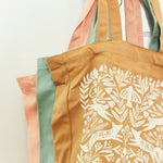 load image into gallery viewer, close up shot of 3 tote bags showing color comparision--from back to front coral pink, ocean blue, burnt orange.
