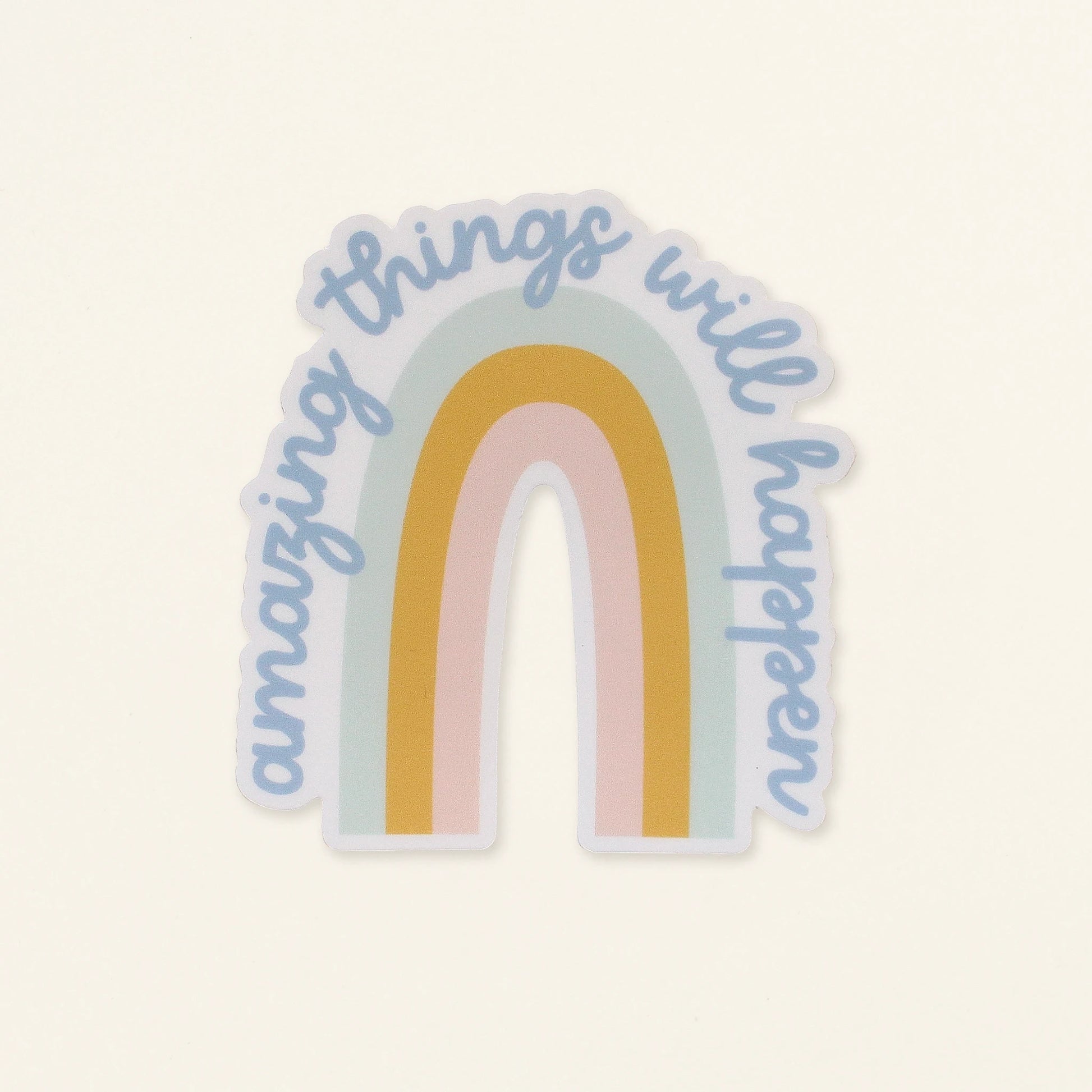 Sticker with rainbow design and 'amazing things will happen' text on a light background