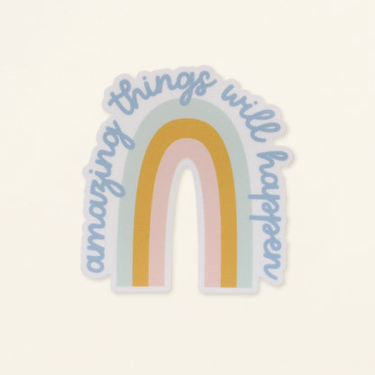 Sticker with rainbow design and 'amazing things will happen' text on a light background