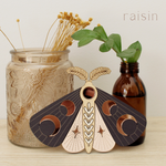 load image into gallery viewer, wooden moth with moon phase design. painted in blush pinks and deep plum with wood tones and mirrored rose gold moon phase inlays.
