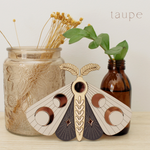 load image into gallery viewer, wooden moth with moon phase design. painted in deep plum and taupe with wood tones and mirrored rose gold moon phase inlays.
