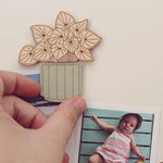 load image into gallery viewer, wooden houseplant magnets shown holding up pictures against a white background.
