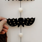 load image into gallery viewer, vertical bats wooden folk halloween garland, black and white starburst
