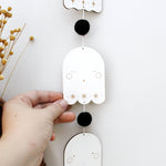 load image into gallery viewer, vertical ghosts wooden folk halloween garland, black and white starburst
