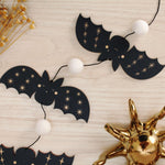 load image into gallery viewer, vertical bats wooden folk halloween garland, black and white starburst
