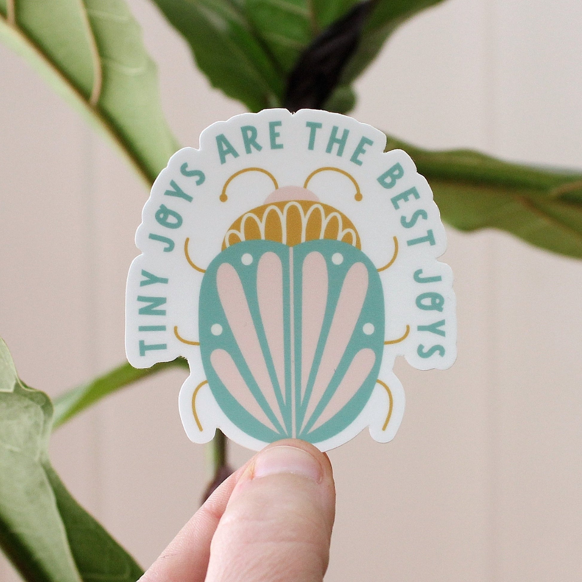 vinyl sticker with turquoise, mustard and peach beetle and the words tiny joys are the best joys