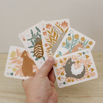 load image into gallery viewer, a woodland, forest themed deck of cards featuring beautifully illustrated animals, flowers and mushrooms. 
