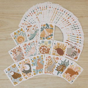 a woodland, forest themed deck of cards featuring beautifully illustrated animals, flowers and mushrooms. 