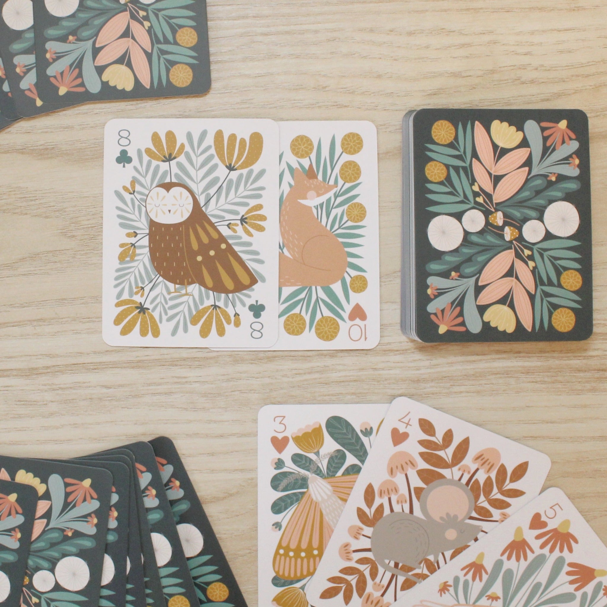 a woodland, forest themed deck of cards featuring beautifully illustrated animals, flowers and mushrooms. 