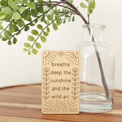mini wooden affirmation card that reads 'breathe deep the sunshine and the wild air.'