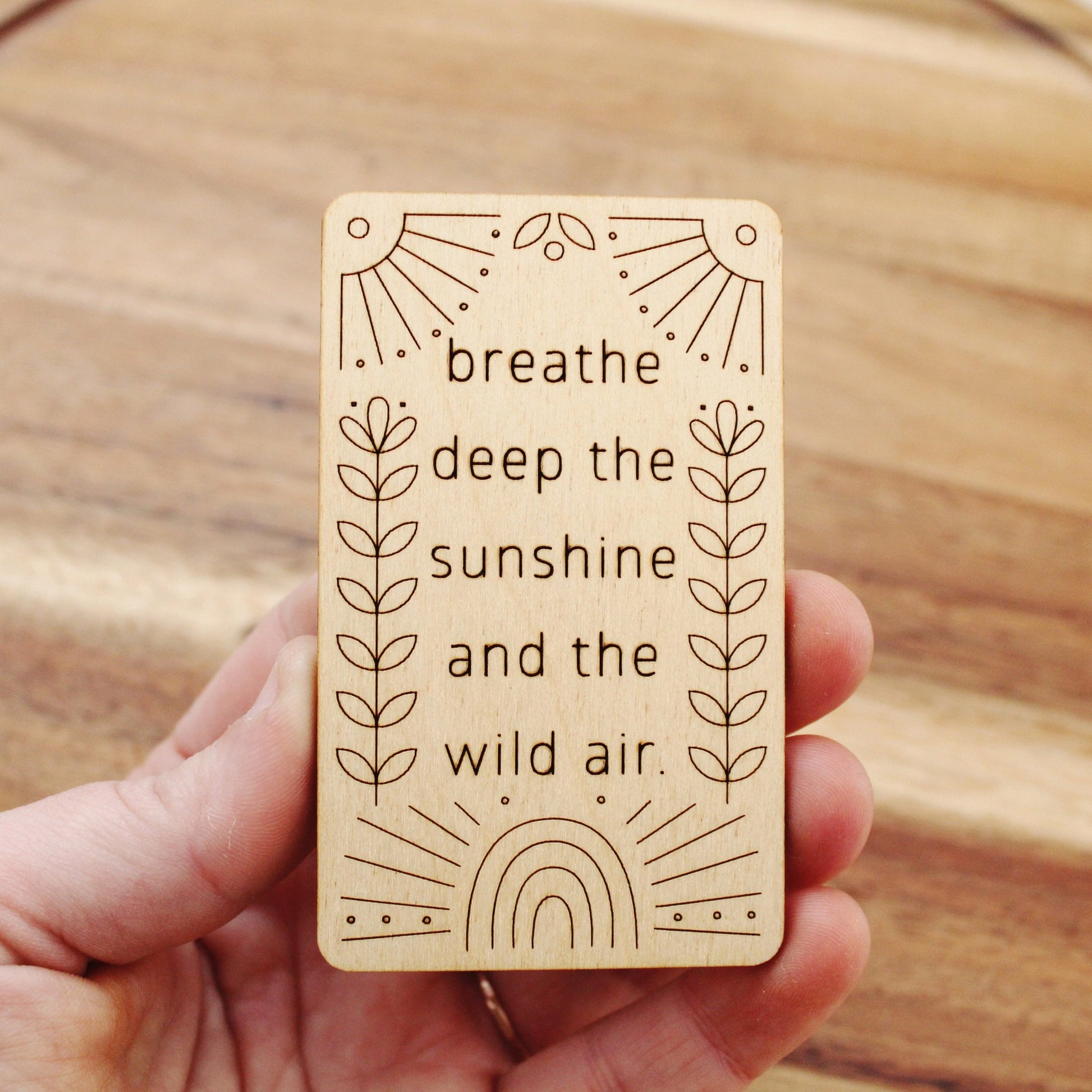 mini wooden affirmation card that reads 'breathe deep the sunshine and the wild air.'