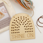 load image into gallery viewer, wooden rainbow banner stitching kit with shine on text and and yarn to stitch yourself.
