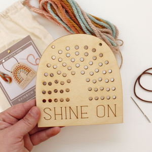 wooden rainbow banner stitching kit with shine on text and and yarn to stitch yourself.