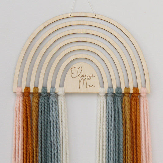 personalized wood and yarn rainbow wall hanging