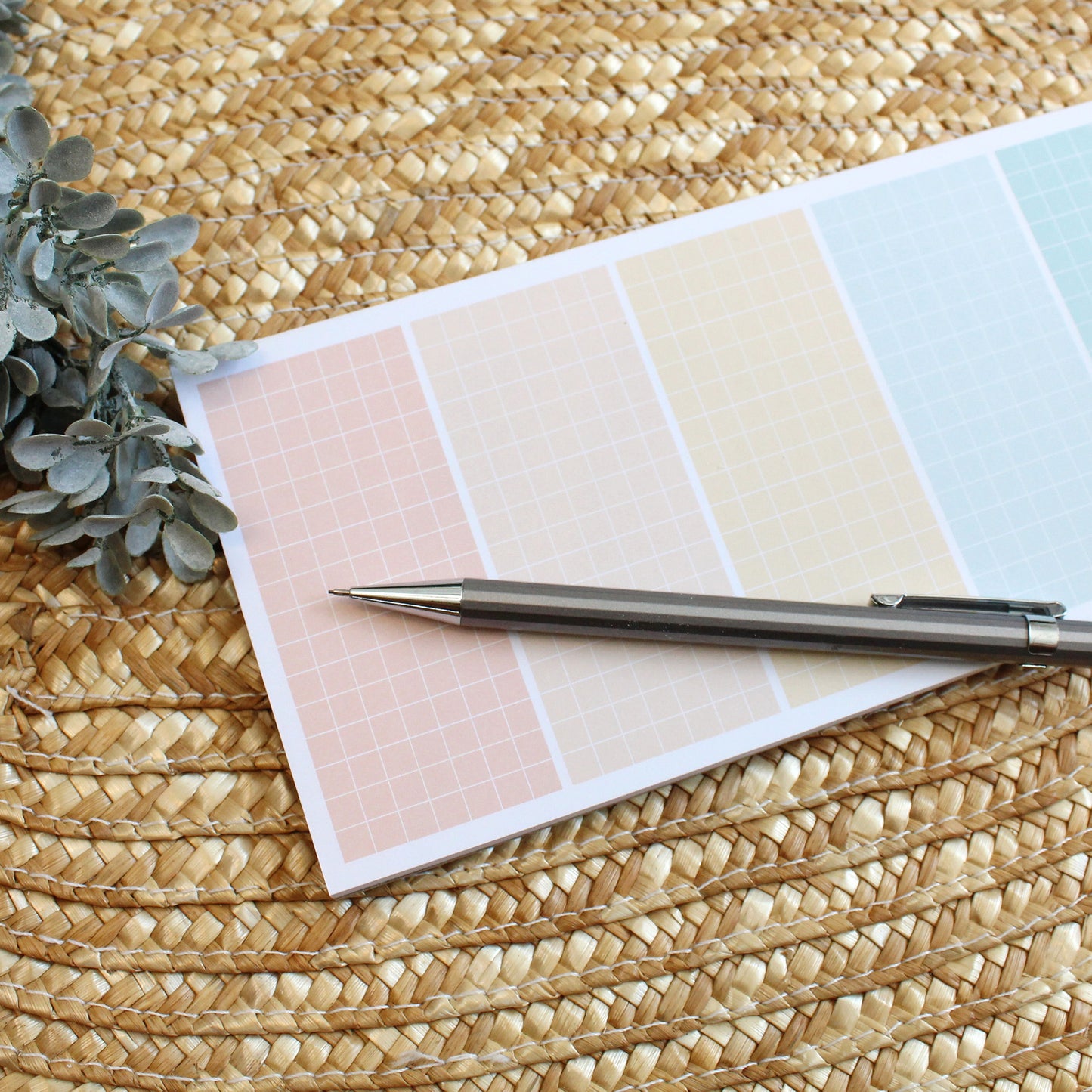 grid lined notepad with 7 rainbow colored sections.