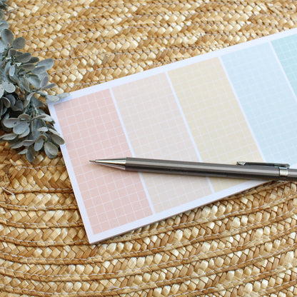 grid lined notepad with 7 rainbow colored sections.