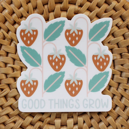 strawberry vinyl sticker in red and green with the words good things grow in light blue