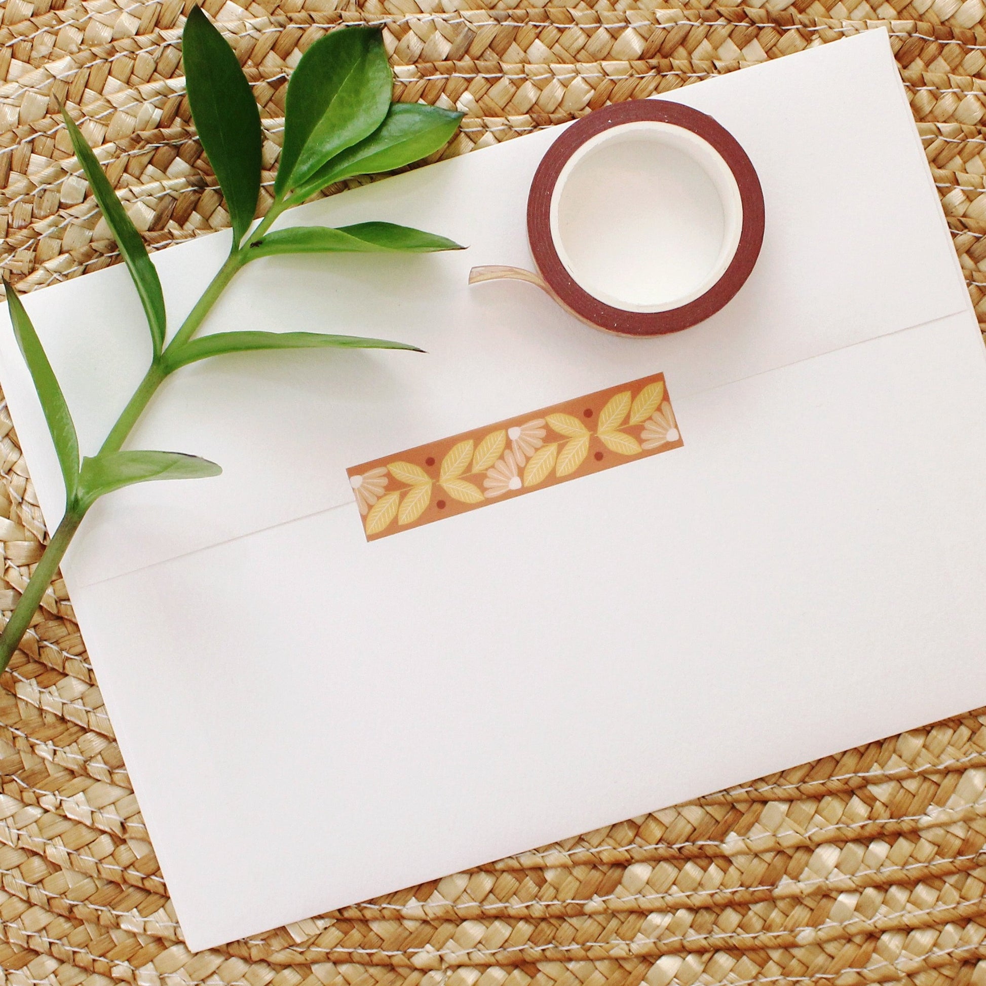 peach and yellow flower washi tape on a rust colored background.