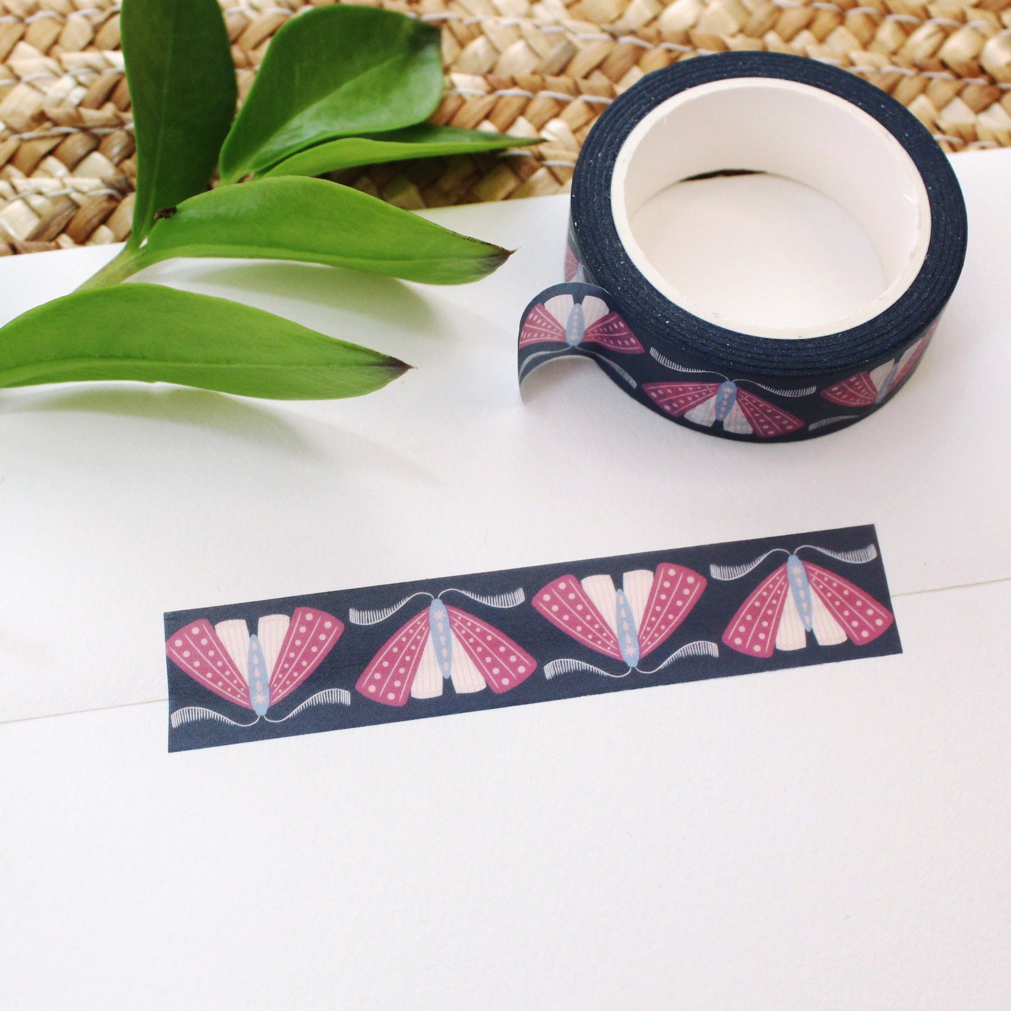 washi tape with purple, blue and pink moths on a deep navy background.