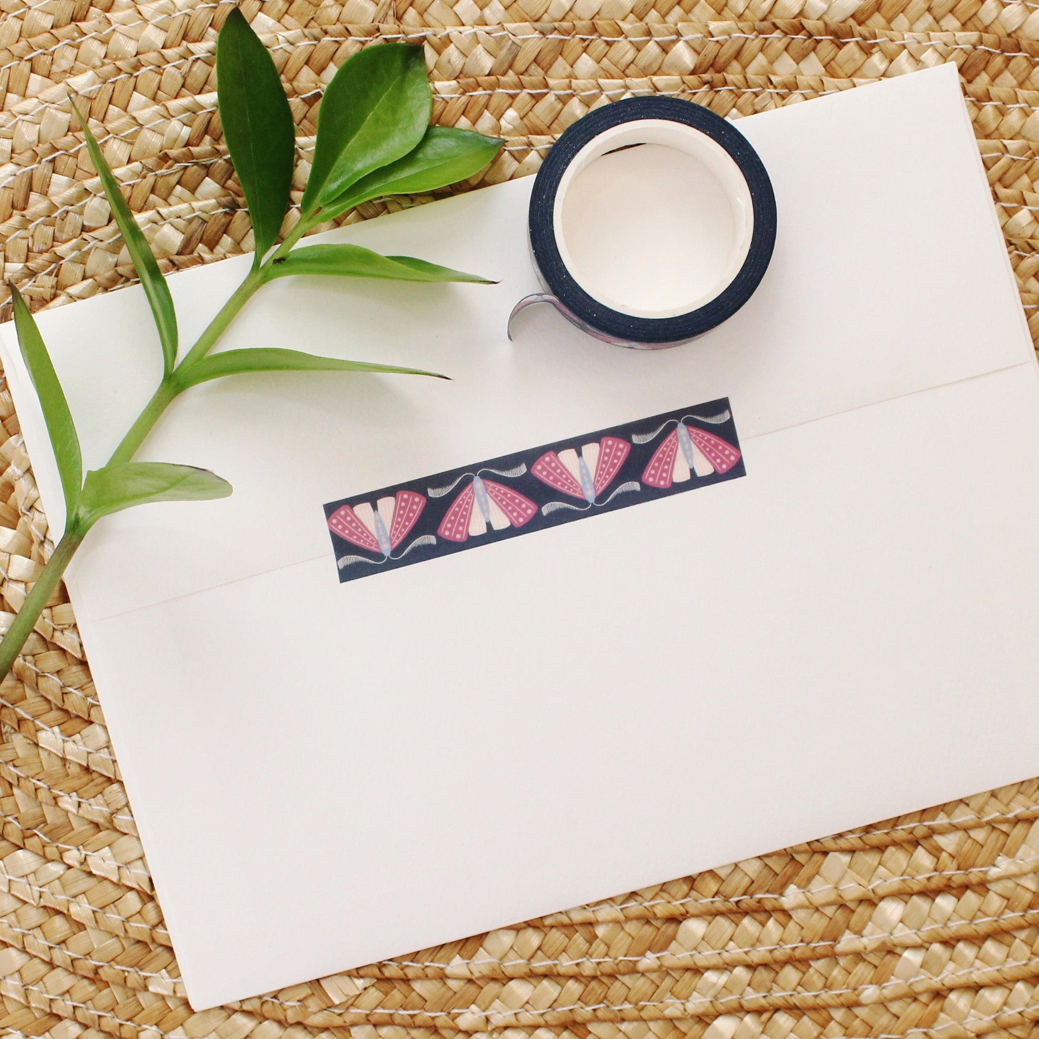 washi tape with purple, blue and pink moths on a deep navy background.