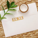 load image into gallery viewer, cute bunny washi tape on a mustard background with pops of plum and peach color.
