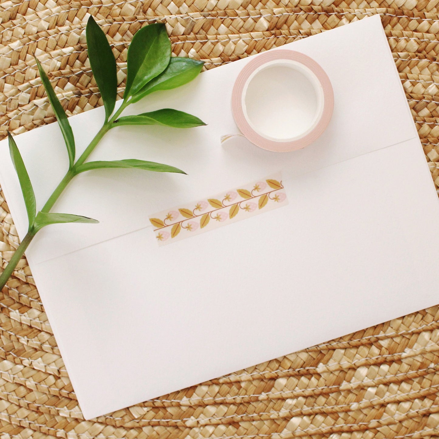 adorable pink strawberry washi tape with mustard yellow leaves on a cream background.